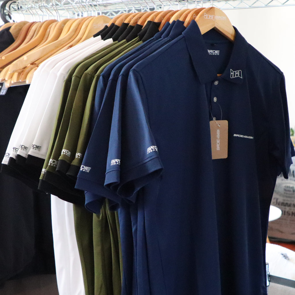Birdie Assassin Golf Polos hanging on a rack