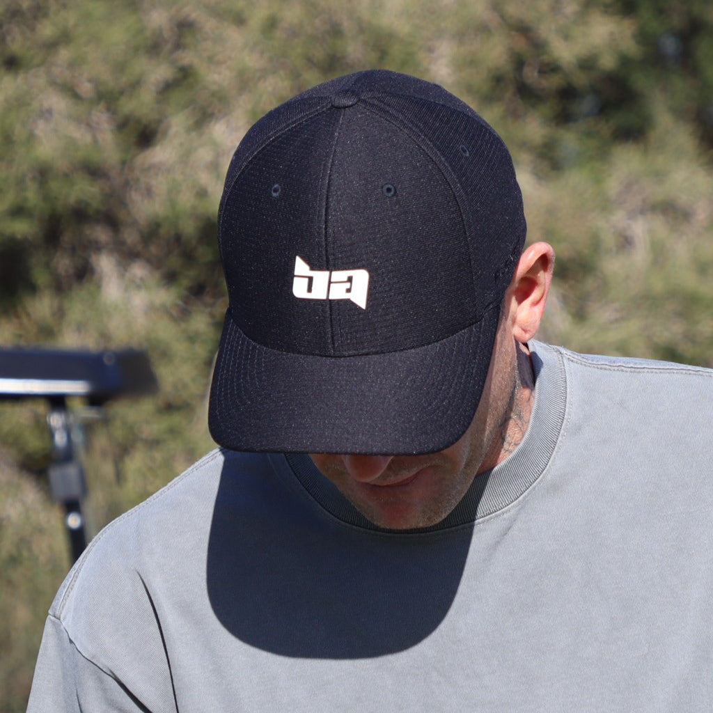 Person wearing a Black Birdie Assassin Players Golf Cap on a golf course