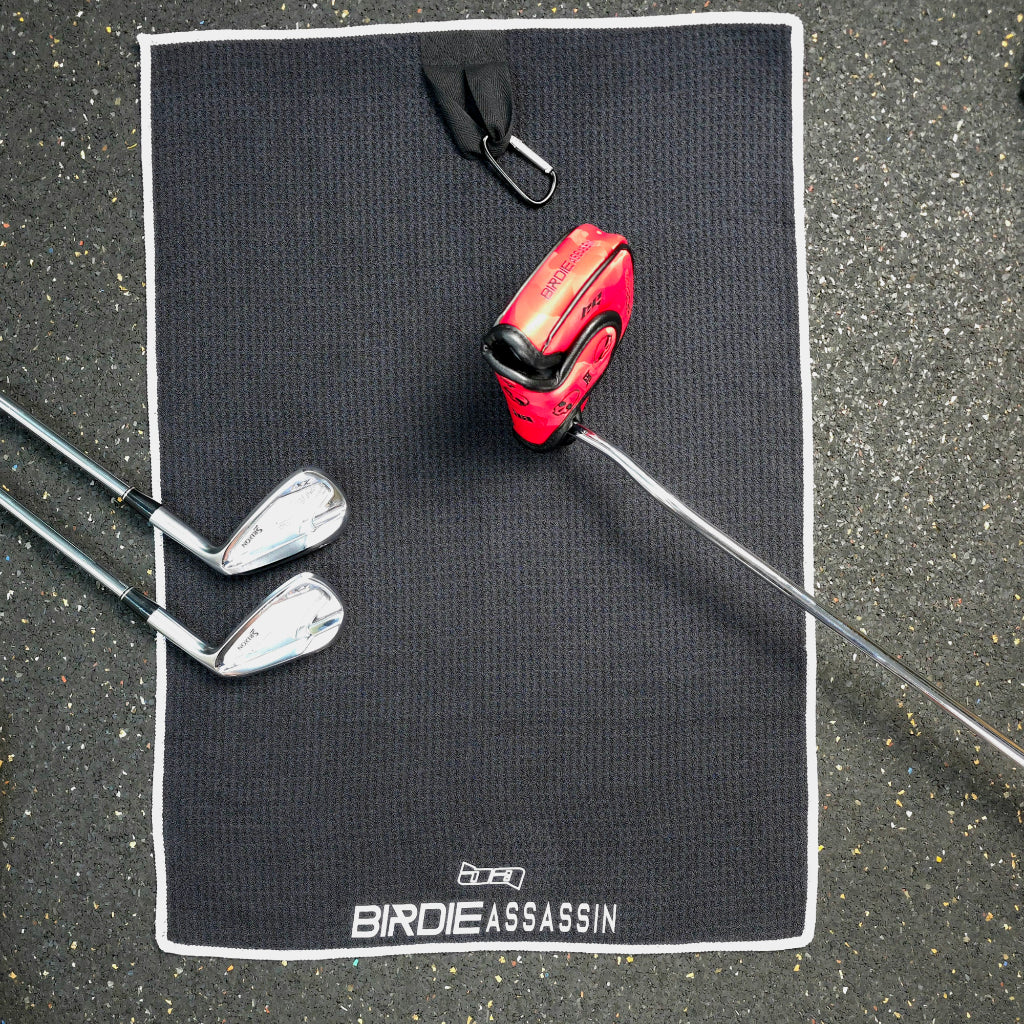 Birdie Assassin golf towel lying on the ground